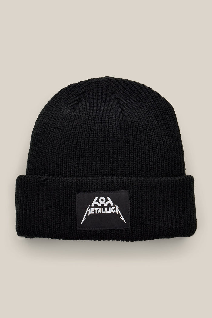 Black 686 Metallica Cuff Beanie made of ribbed knit with a rectangular patch featuring a white Metallica logo.