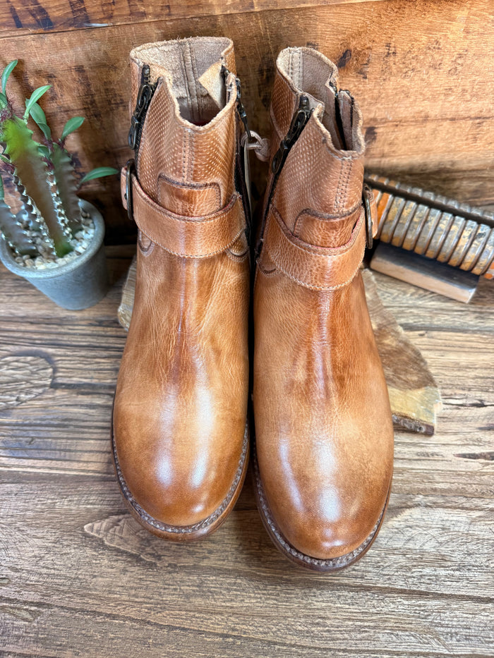 Pair of tan leather ankle boots with strap buckle and side zipper