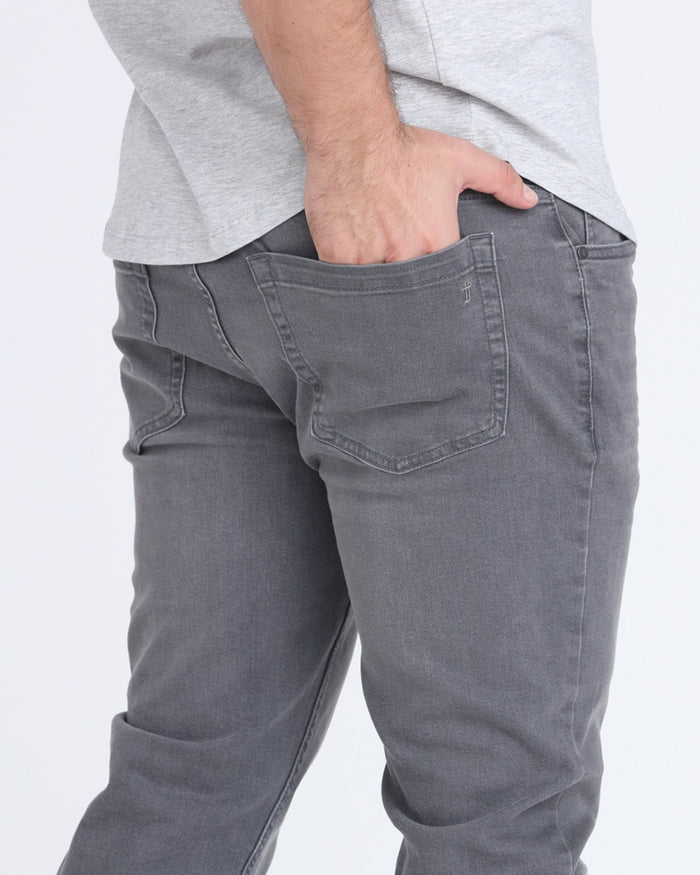 Grey bootcut jeans with five-pocket styling and visible stitching detail on back pocket.