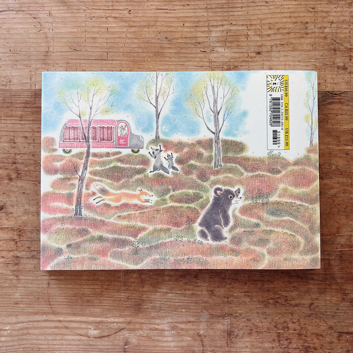 The back cover of the book showing an illustration with animals and a camper on a wooden surface