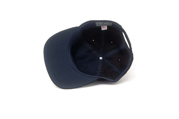 Interior view of the LA City Series Snapback in Black Corduroy showing the navy herringbone lining and The Ampal Creative label