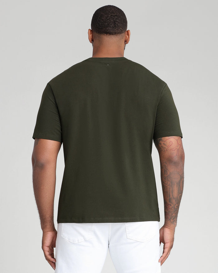 Man wearing olive green crew neck t-shirt with short sleeves, shown from back view.