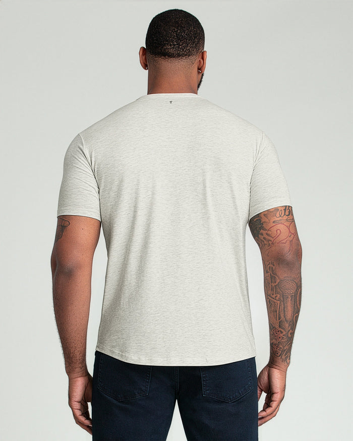 Oatmeal heather crew neck t-shirt with short sleeves, shown from back on model wearing dark jeans.