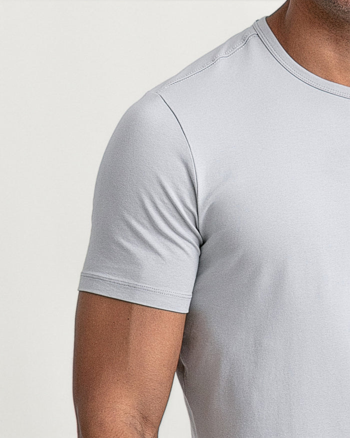 Light grey crew neck t-shirt with short sleeves worn by a person shown from shoulder to chest.