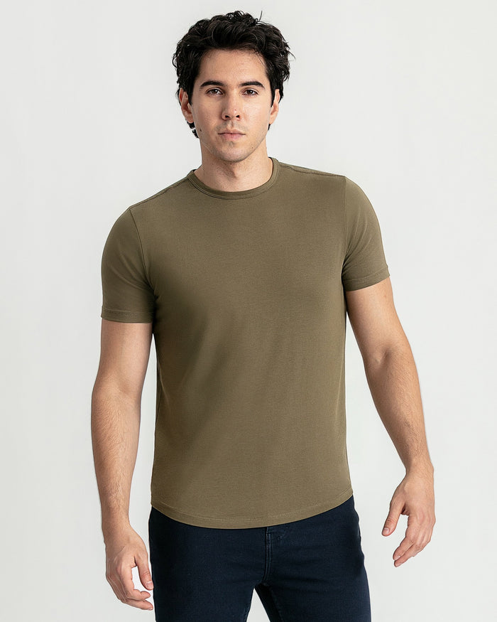 Man wearing military olive crew neck t-shirt with short sleeves and dark jeans.