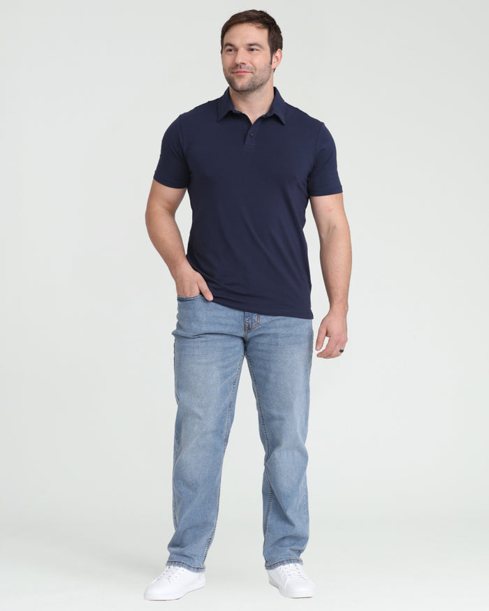 Navy polo shirt with short sleeves and collar, worn with light blue jeans.