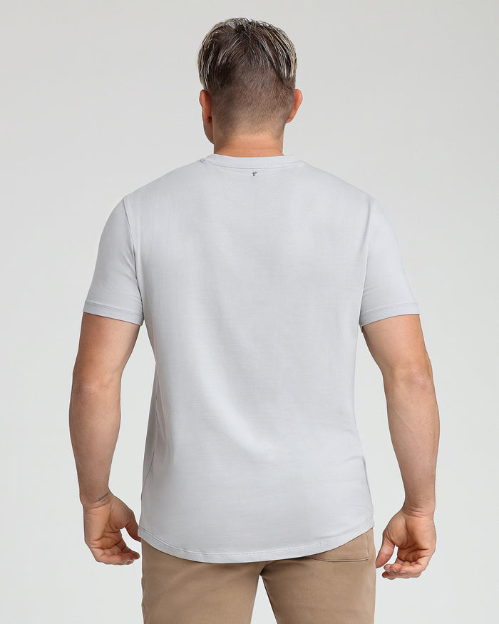 Man wearing light gray v-neck t-shirt, back view.