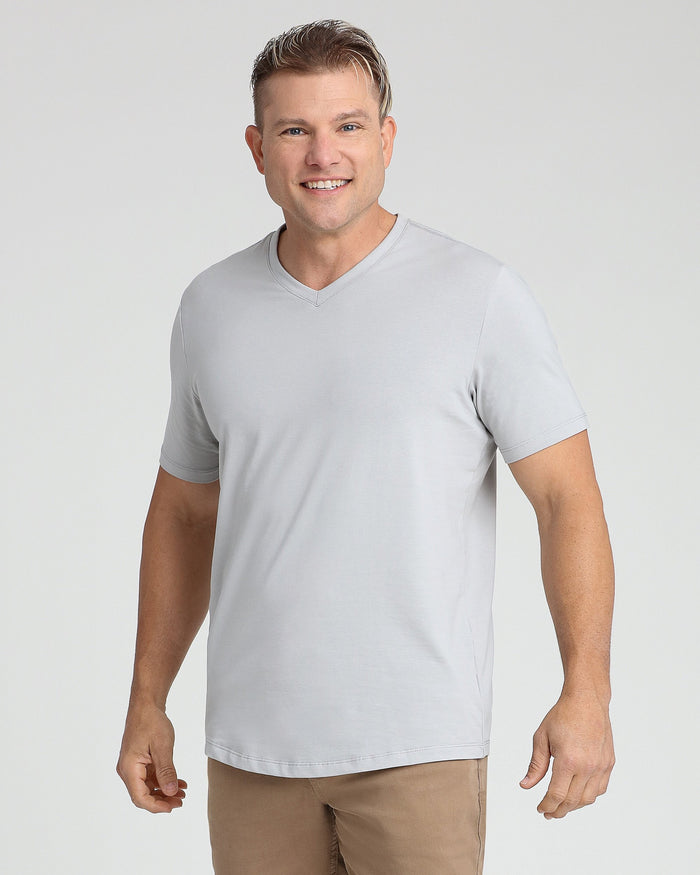 Light grey v-neck t-shirt with short sleeves on a male model wearing tan pants.