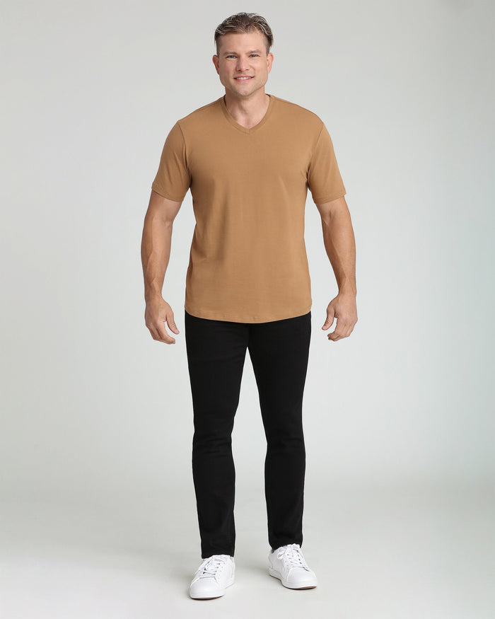 Man wearing tobacco brown v-neck t-shirt with short sleeves and black pants.