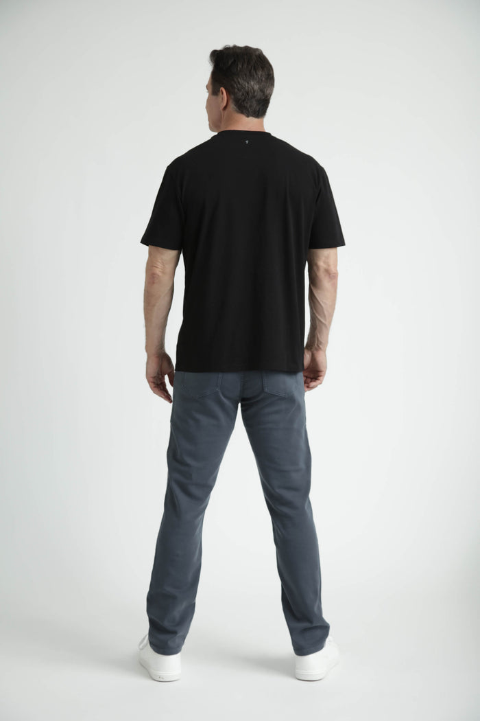 Man wearing black crew neck t-shirt with short sleeves, shown from back view.