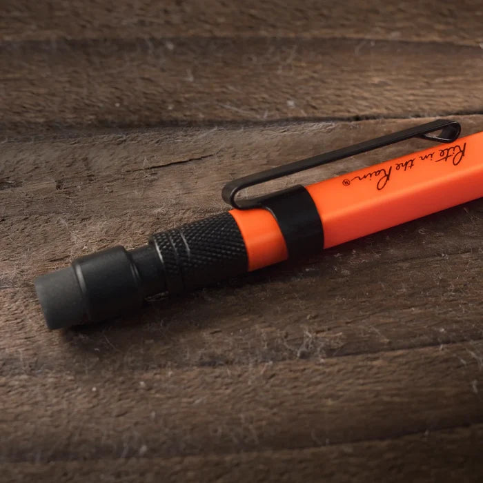 Orange and black pen on a wooden surface