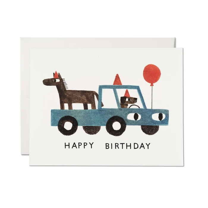 Birthday card with a blue truck carrying a horse and a dog, and a red balloon.