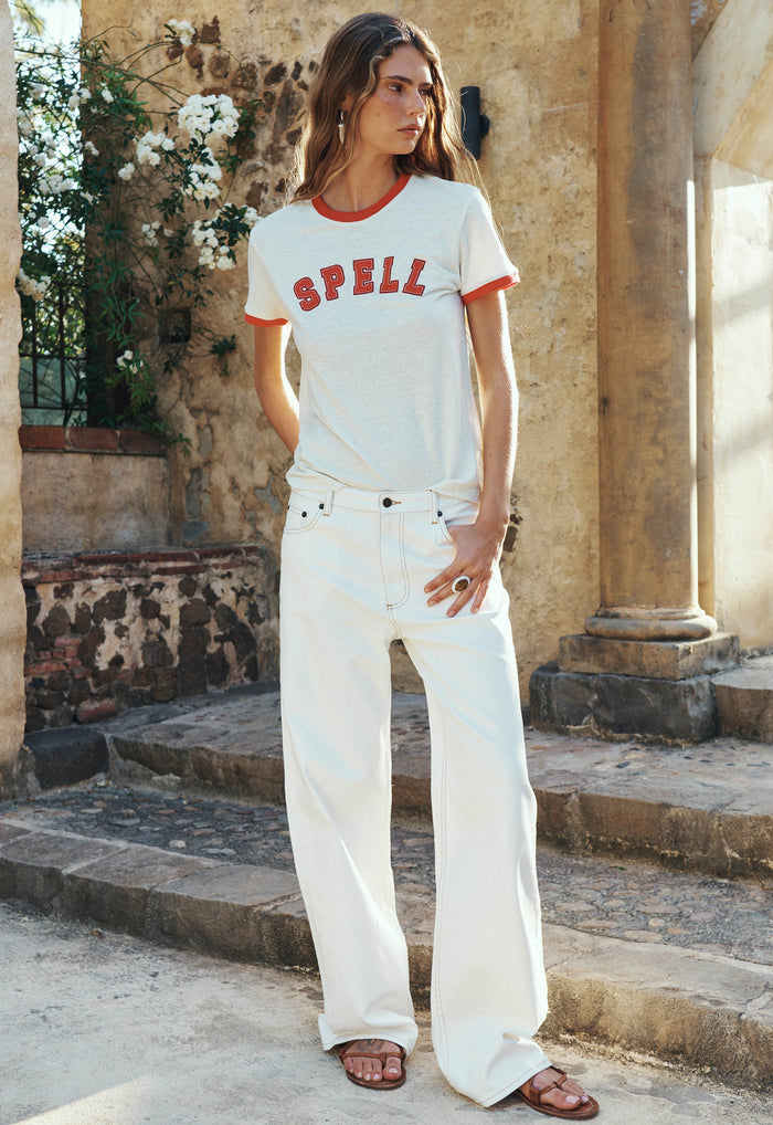 Model wearing salt white organic cotton baggy jeans, front view, styled with ringer tee, outdoor setting
