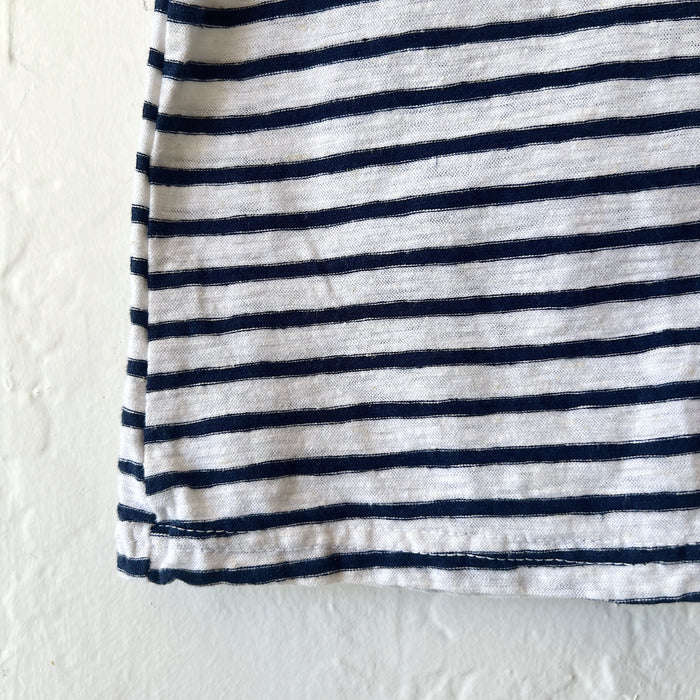 Close-up of navy and white striped fabric on a textured white background