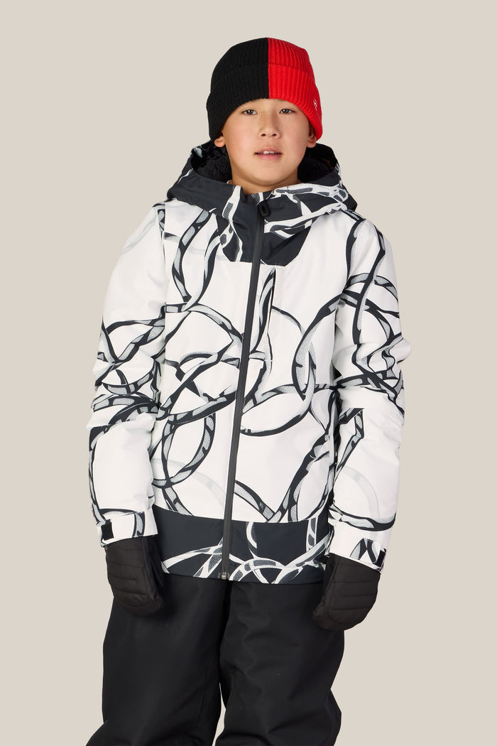A child wearing the 686 Boys’ Gateway™ Insulated Jacket by 686, along with black pants, black gloves, and a red and black beanie, stands against a plain light-colored background.