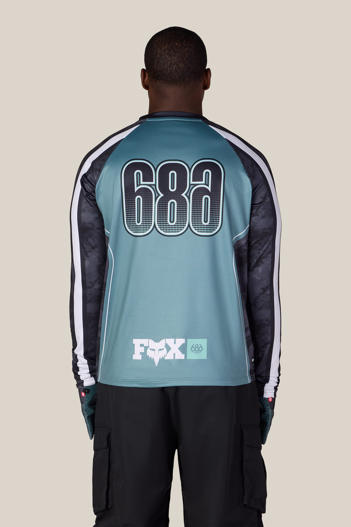A person seen from the back wearing a 686 Men’s Fox Racing Base Layer LS.