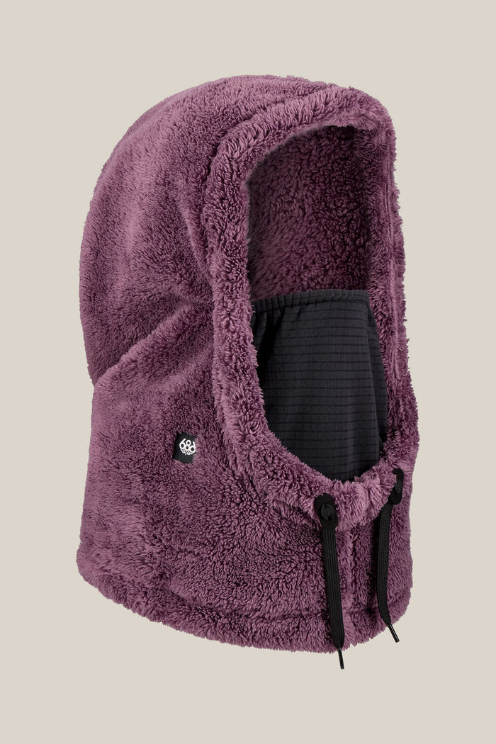 The 686 Tarmac Sherpa Hood by 686 is a plush, purple fleece polyester knit hood featuring black drawstrings and a small logo tag on the side, displayed against a plain light background. Designed in a unisex facemask style, it offers both comfort and versatility.