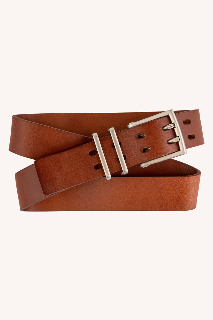 The Westwell 686 Westwell Voyager Belt features brown leather, a silver rectangular buckle, and two loops, displayed coiled in a loose spiral against a plain light background.