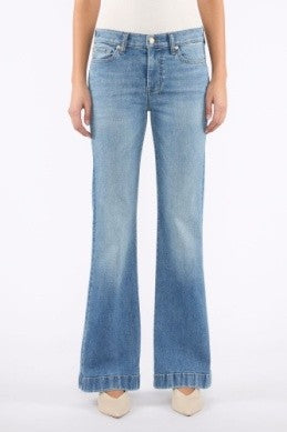 Light blue flared jeans worn by a person on a white background