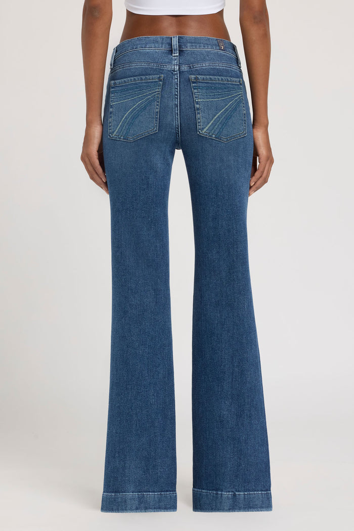 Blue jeans worn by a person on a white background