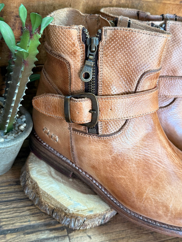 Tan leather ankle boots with padded collar, buckle strap, side zipper