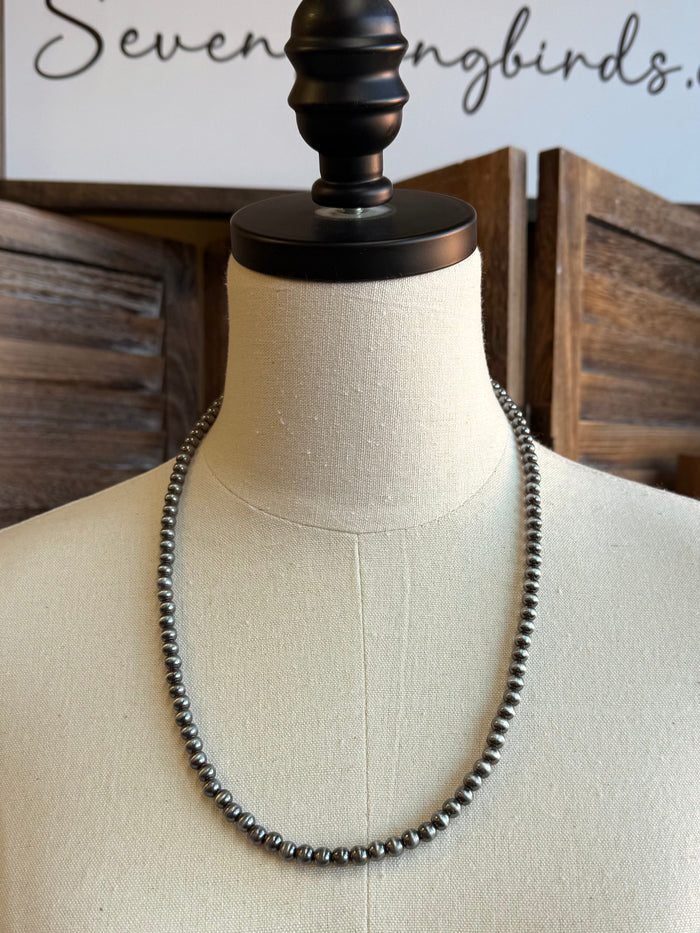 Silver-tone round bead necklace on mannequin, ball-chain style