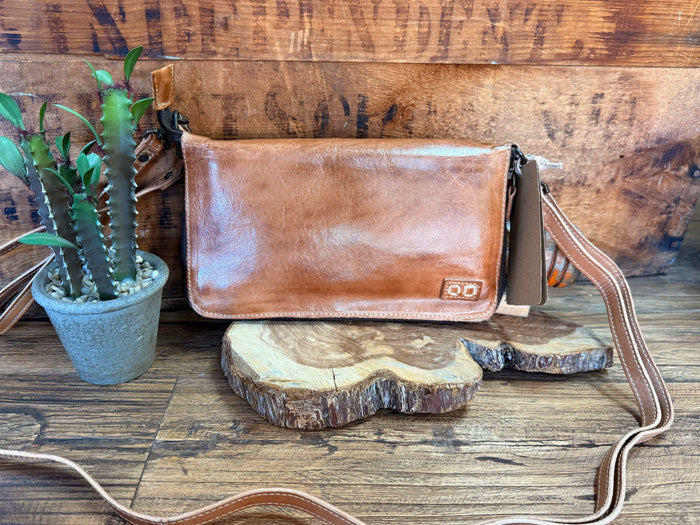 Tan leather crossbody bag with flap and buckle detail