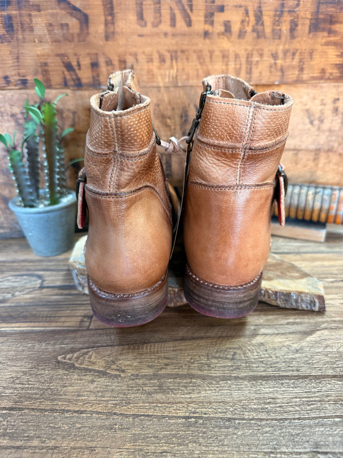 Back view of tan leather ankle boots with pull tabs and side zipper