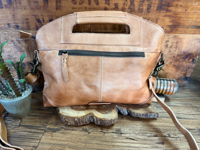Tan leather satchel bag with front zipper pocket and long crossbody strap