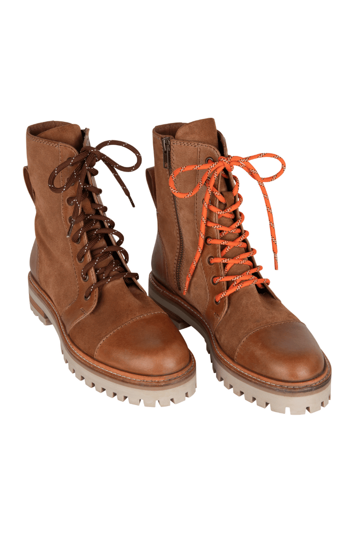 Pair of brown leather boots with orange laces on a white background