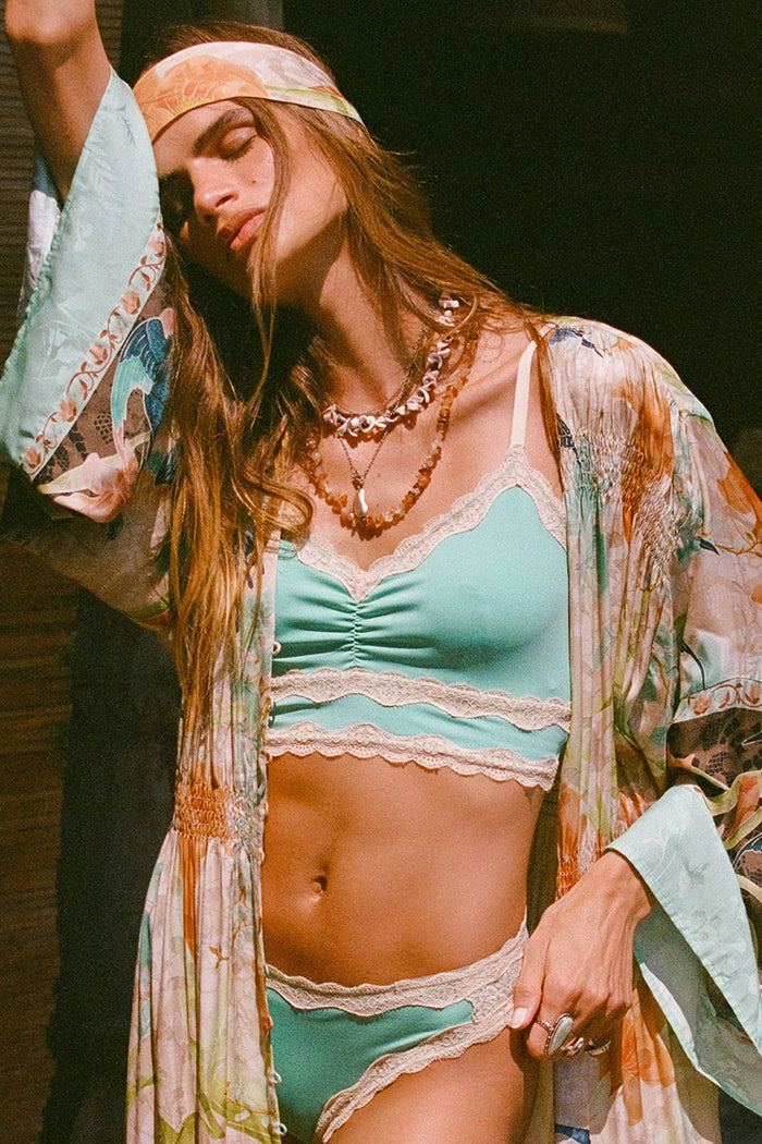 Front view of seafoam lace-border bralette with CF elastic ruching, styled open under a floral kimono