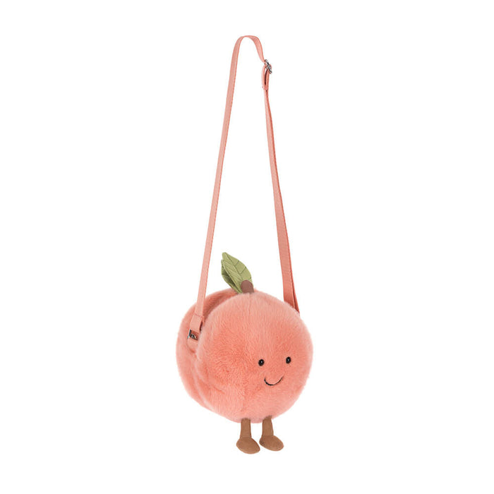 Plush peach-shaped bag with a strap on a white background