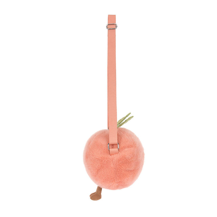 Pink plush ball with a strap on a white background, viewed from the side