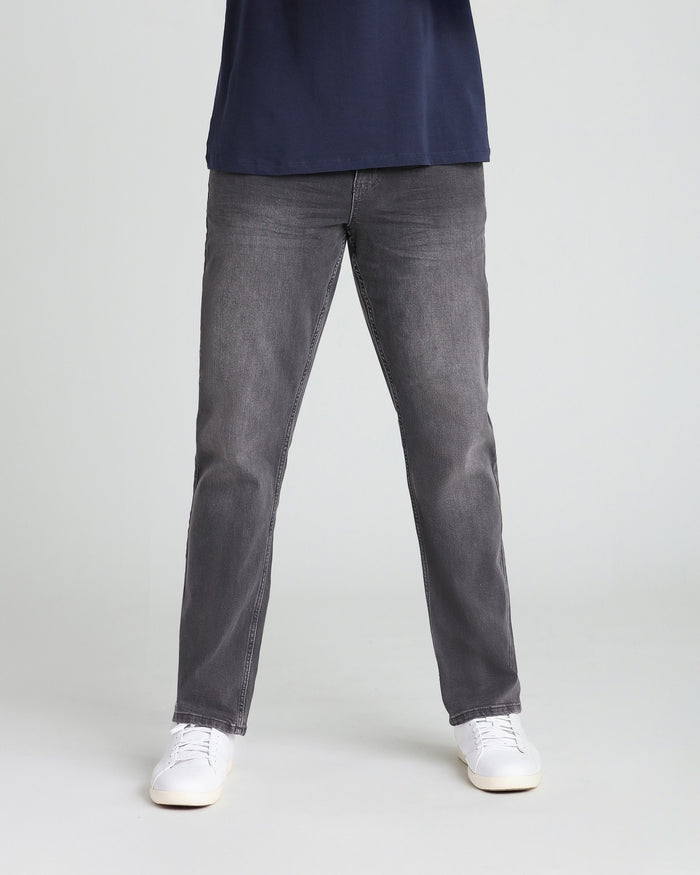 Grey athletic fit jeans with straight leg cut, styled with navy top and white sneakers.
