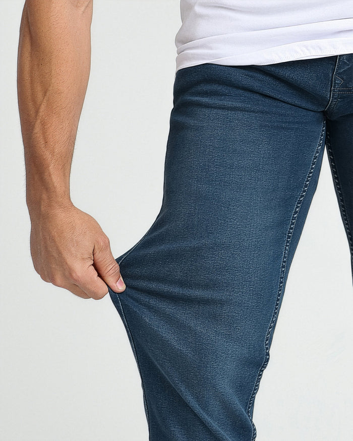 Midnight blue athletic fit jeans on model wearing white t-shirt, showing fabric fit and stitching detail.