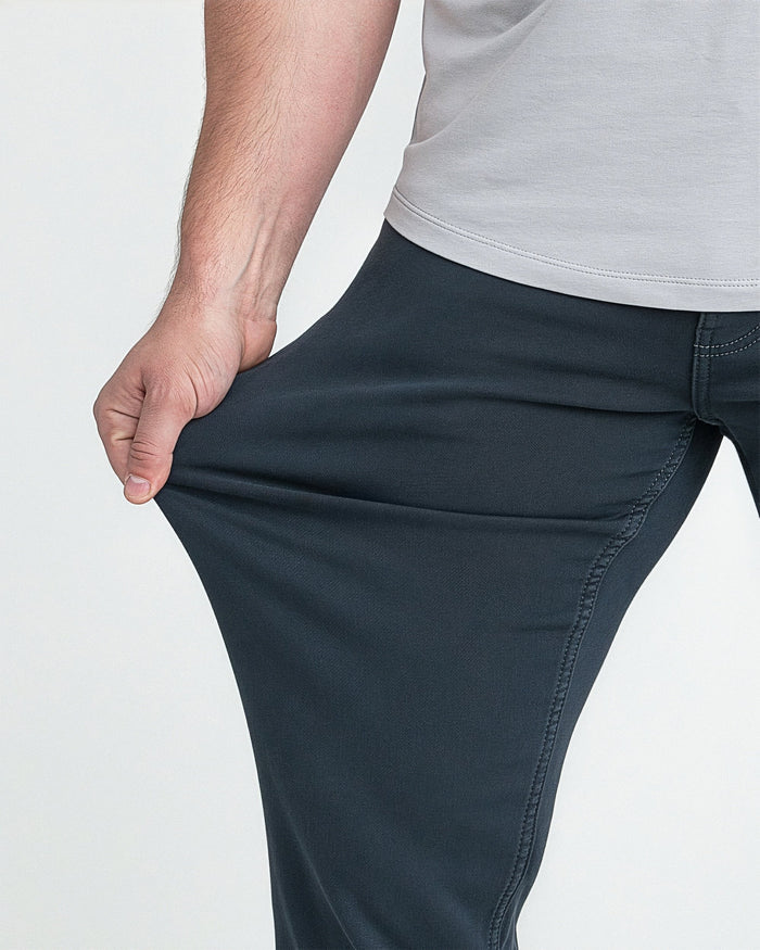 Man wearing slate gray athletic fit pants with gray t-shirt, showing fit at hip and thigh.