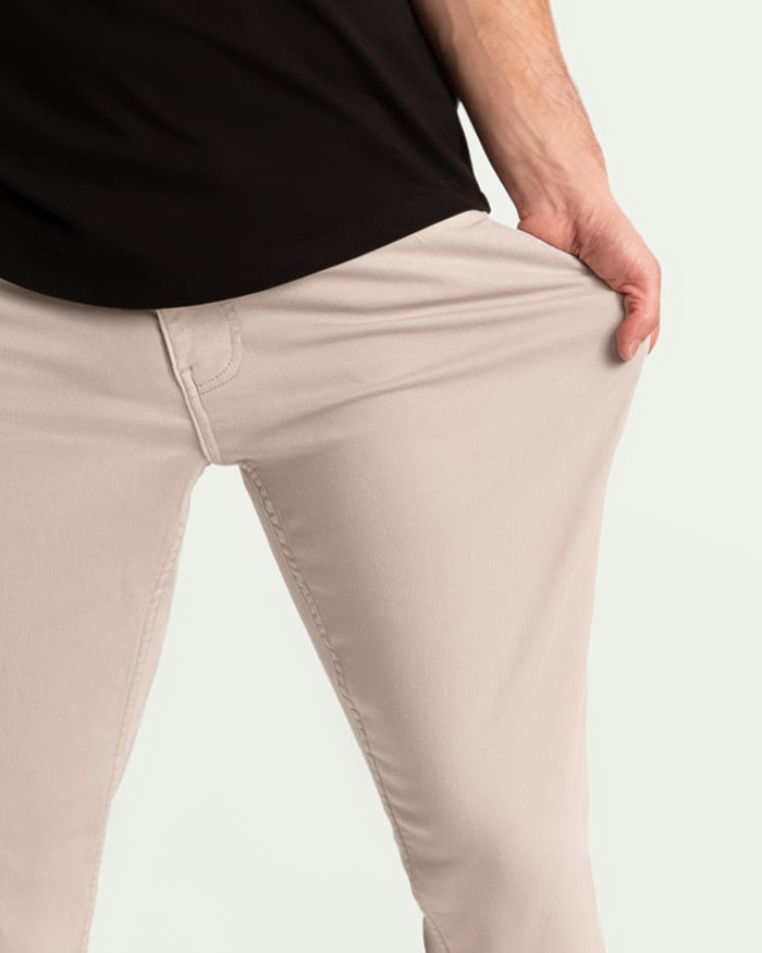 Man wearing light grey athletic fit pants with black shirt, shown from waist down.