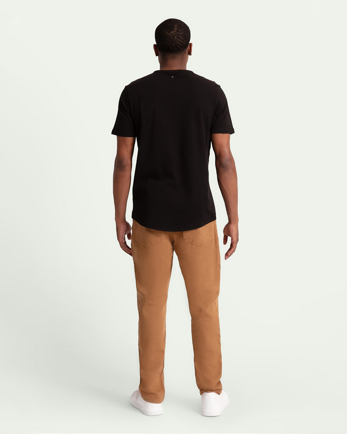 Man wearing black short-sleeve t-shirt and brown athletic fit pants, shown from back view.