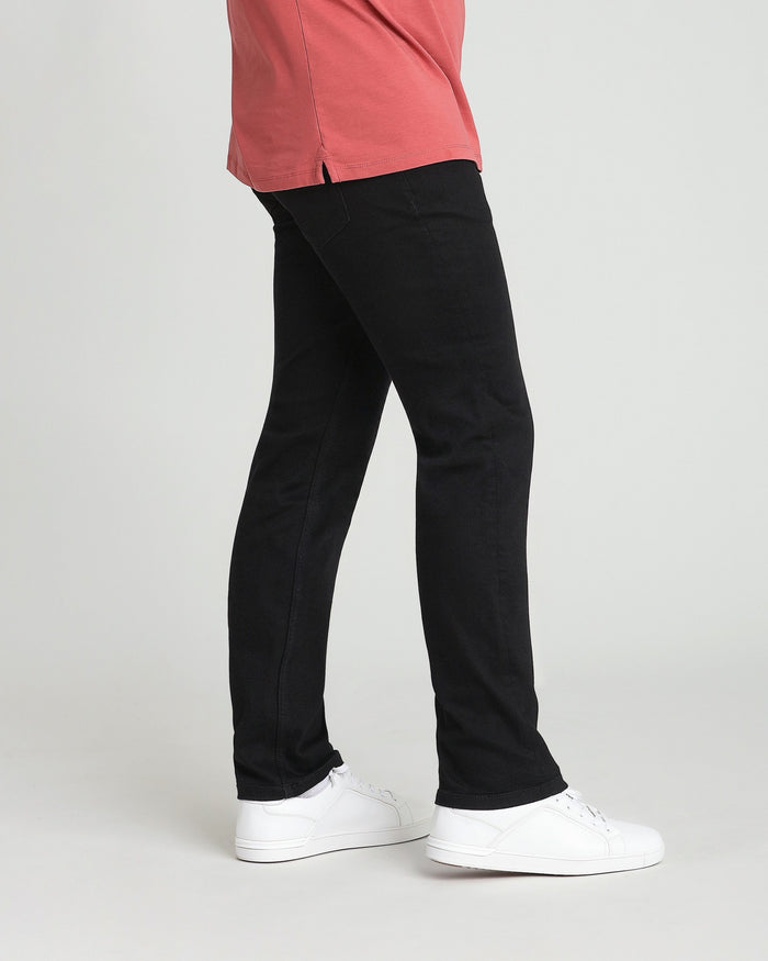 Black athletic fit jeans with straight leg and white sneakers.