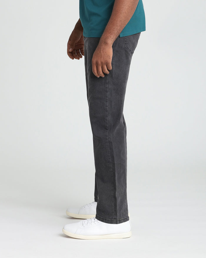 Faded black athletic fit jeans worn with teal shirt and white sneakers.