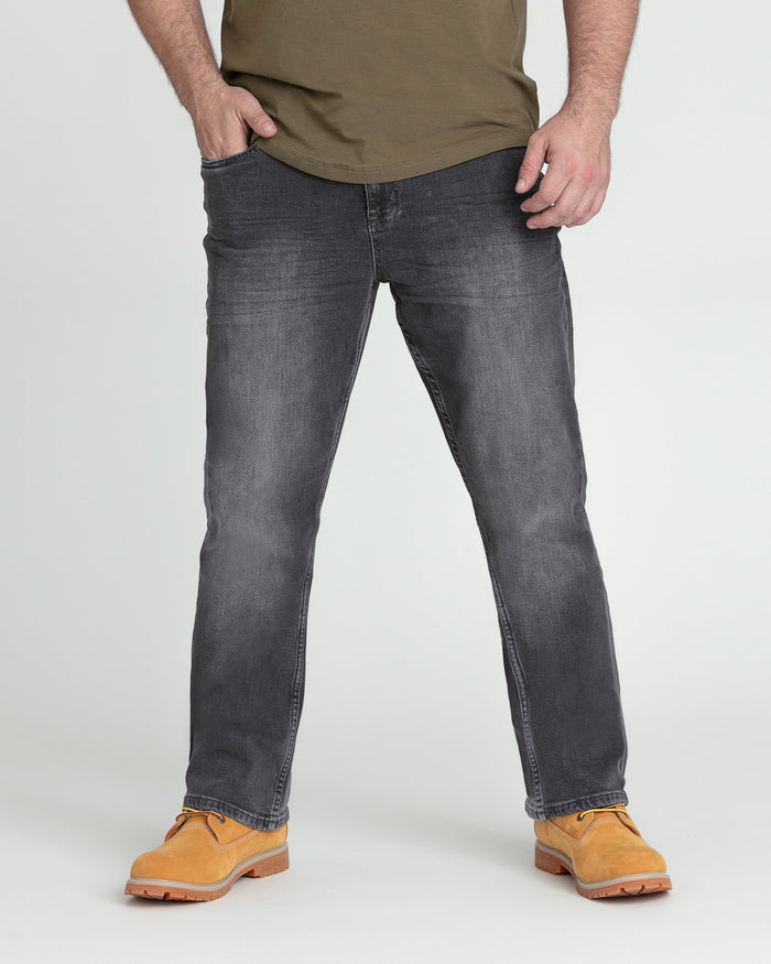 Man wearing grey bootcut jeans with olive shirt and tan work boots.