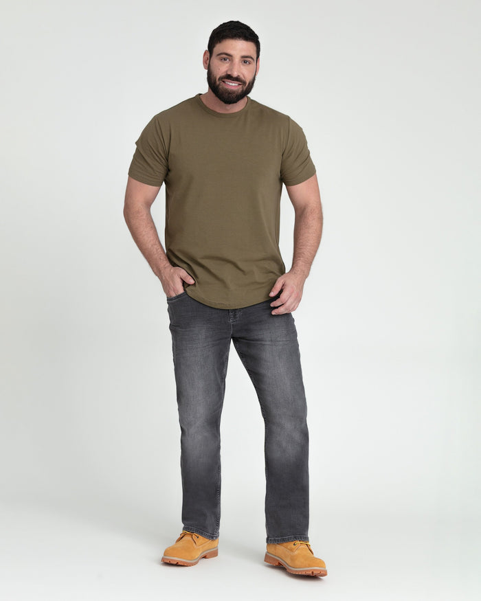 Man wearing olive short-sleeve t-shirt and gray bootcut jeans with tan work boots.