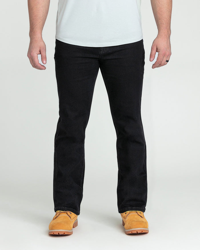 Black bootcut jeans with slight flare from knee down, shown on male model with tan boots.