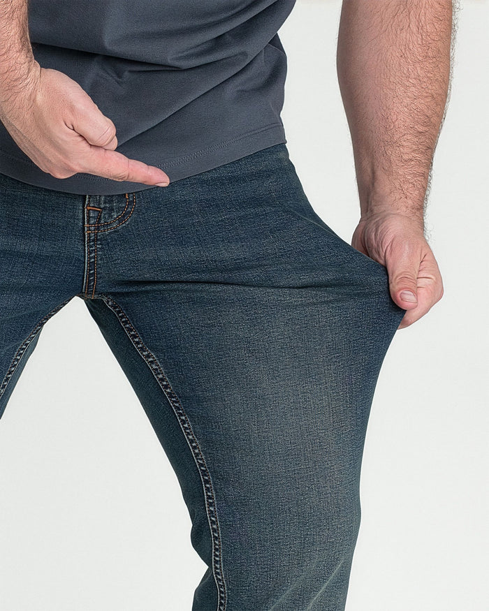Dark tinted bootcut jeans with contrast stitching, shown on model from waist down.