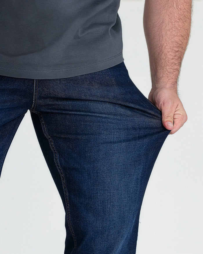 Dark blue bootcut jeans with contrast stitching, shown on model from waist down.