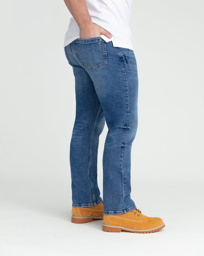 Medium blue bootcut jeans with five-pocket styling and visible stitching detail on the legs.