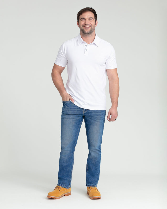Medium blue bootcut jeans with a flared leg opening, worn with a white polo shirt.