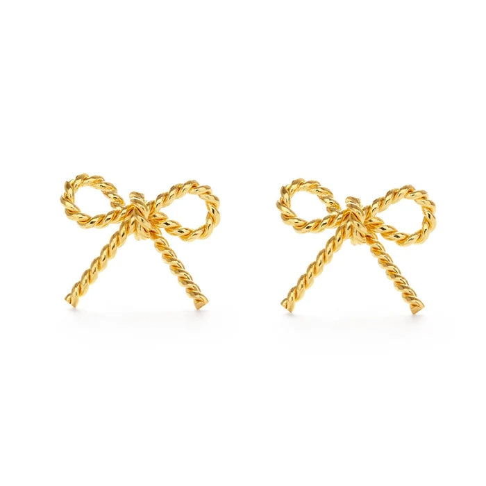 A pair of gold bow stud earrings on a white background.
