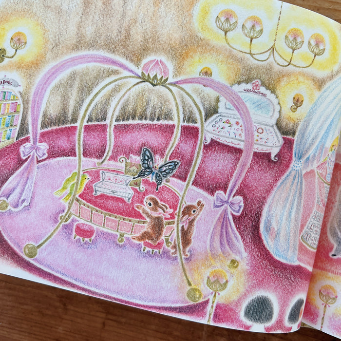Illustrated scene with a pink crib, butterfly, and animals on a wooden surface