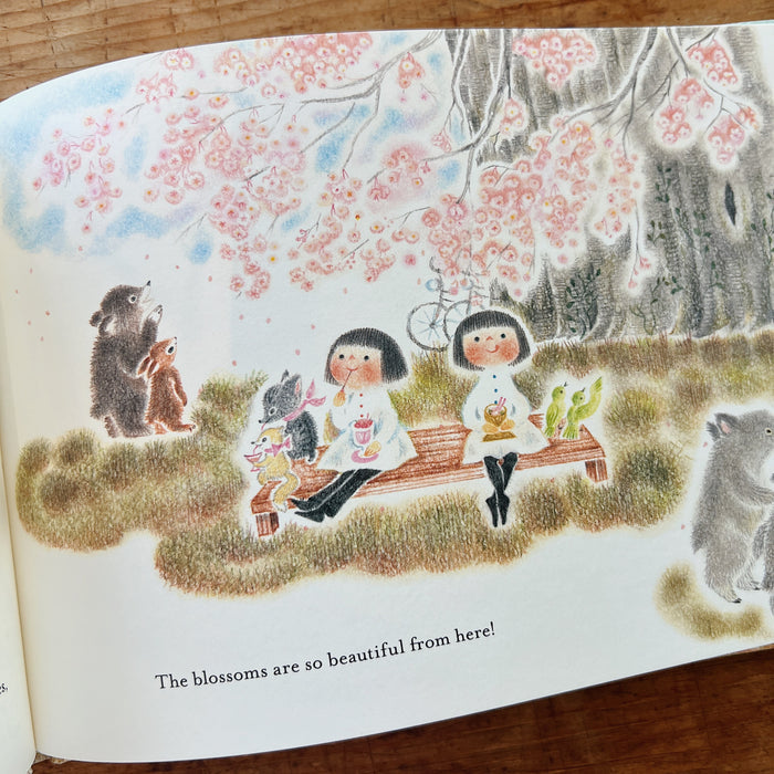 Illustration from a book showing children and animals under cherry blossoms.